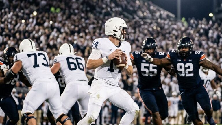 An anonymous professional football quarterback preparing to throw a pass under stadium lights, demonstrating the focus on passing EPA football stats